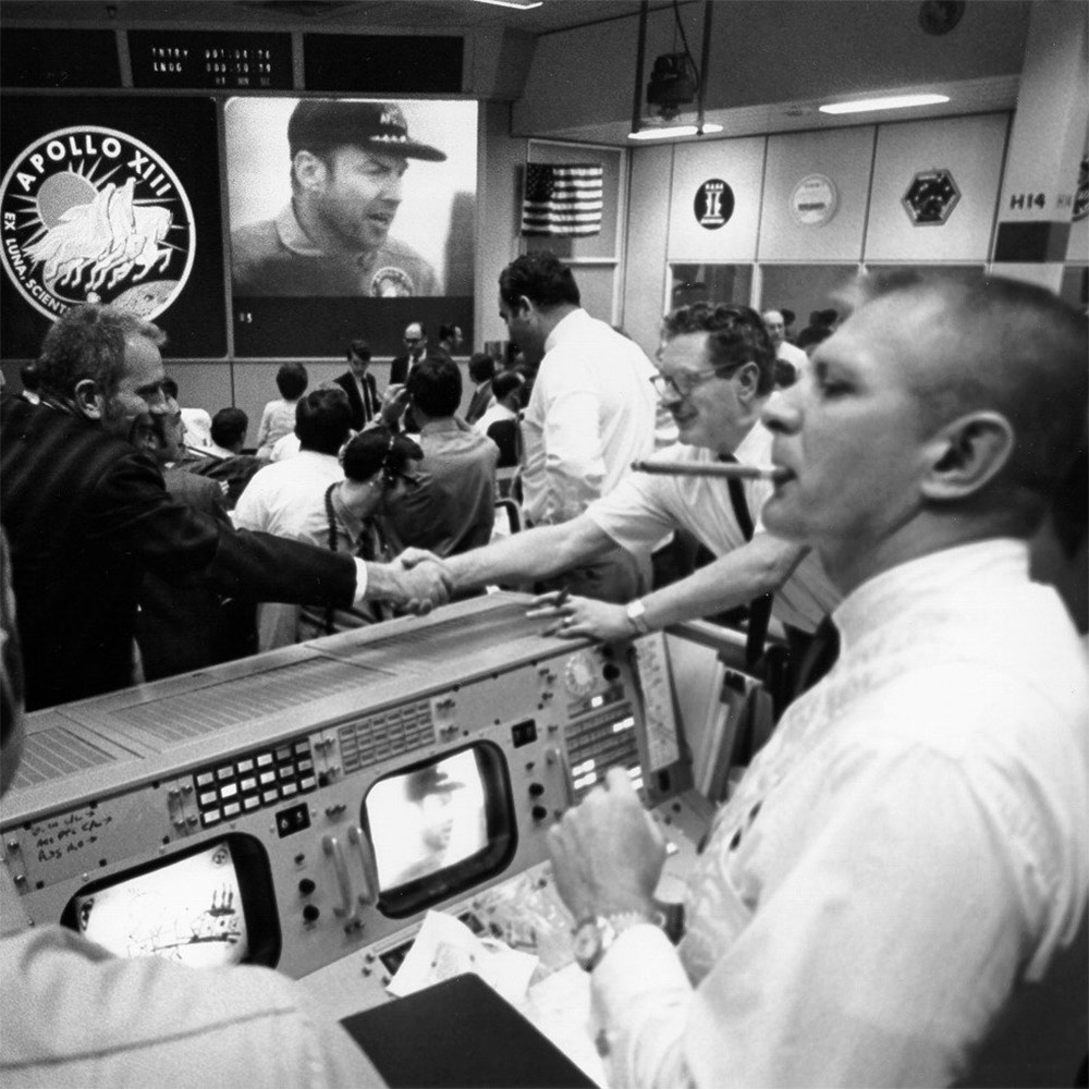 Gene Kranz and Deke Slayton celebrate in Mission Control.